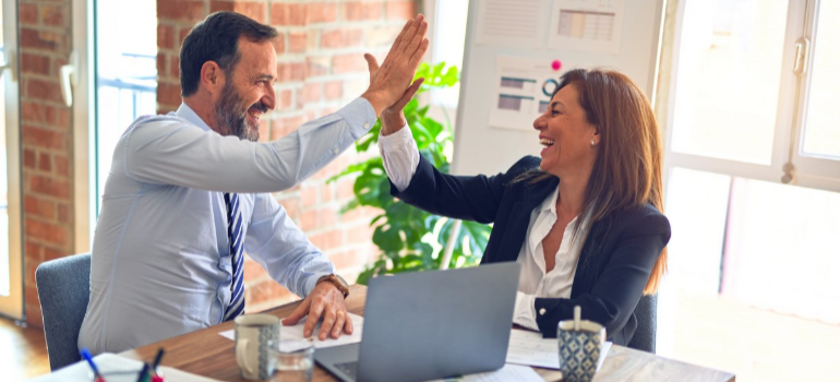 two people throwing a high five