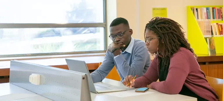 two coworkers doing online research together to find the perfect office space in DC