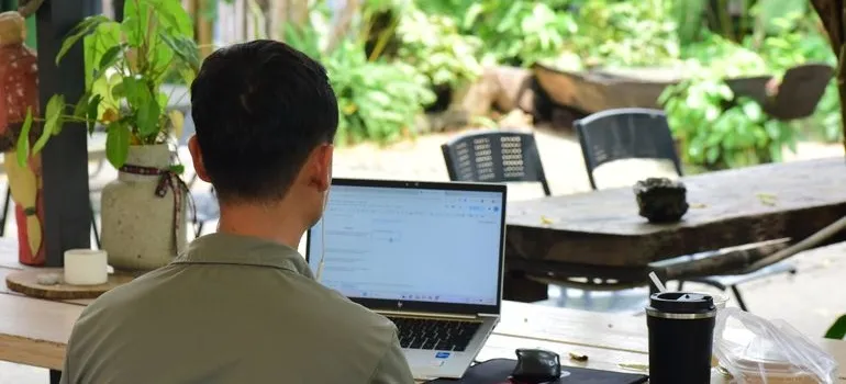 A person using a laptop to research why are people moving out of Rockville