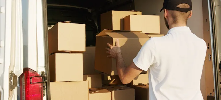 A person loading moving boxes that are ready for moving to Arlington VA