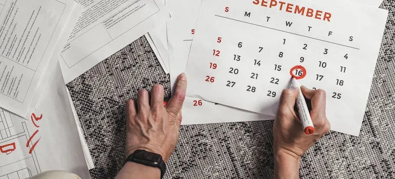 A person circling the date for moving from Bethesda to Gaithersburg