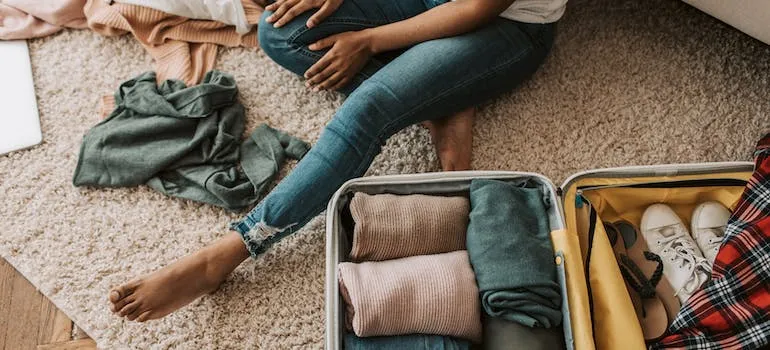 A person packing in the suitcase 