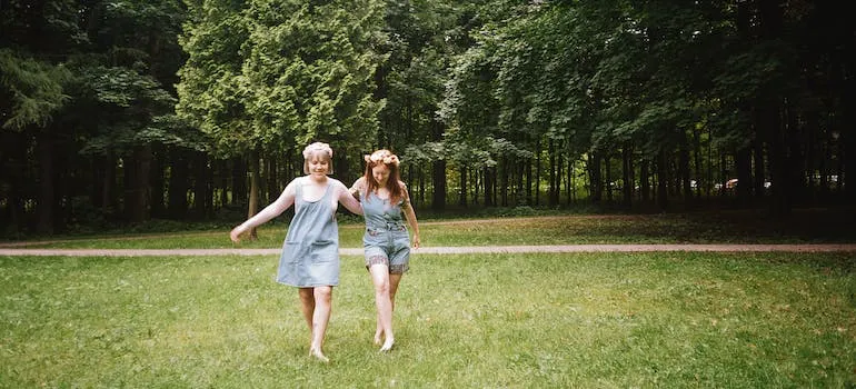 Two women on a grass field 