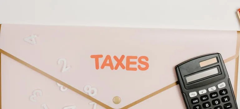 Calculator and envelope labeled taxes