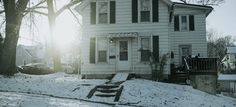 A snow in front of the house