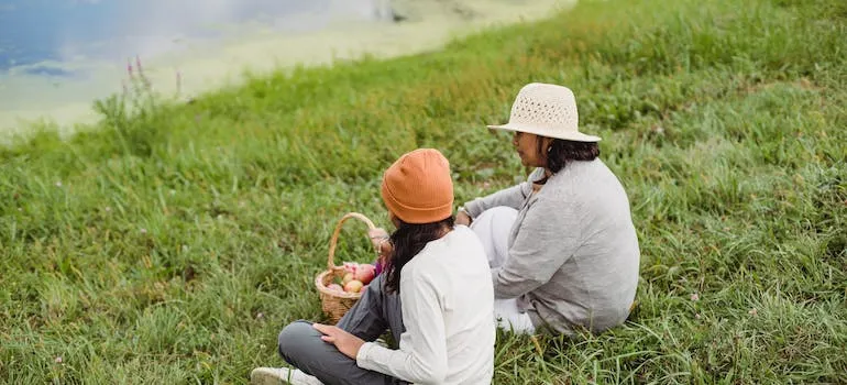 Mother and daughter having picnic in the park