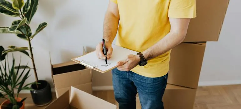 A man standing next to the moving boxes