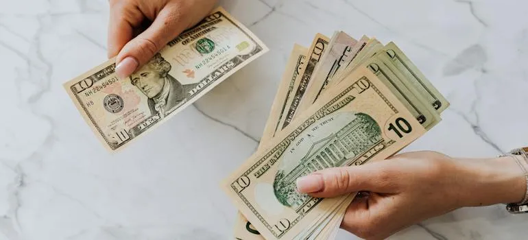 A person holding dollar bills