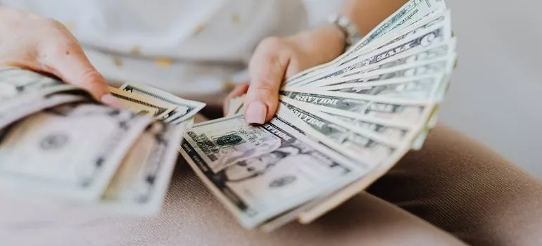 A person holding dollar bills 