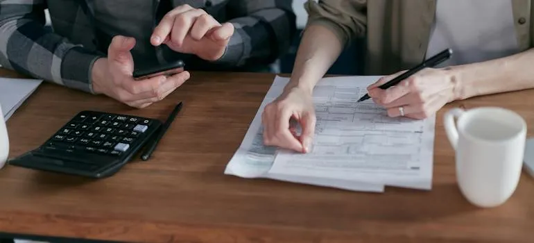 A person doing paperwork and trying to understand tax differences between Maryland and Virginia
