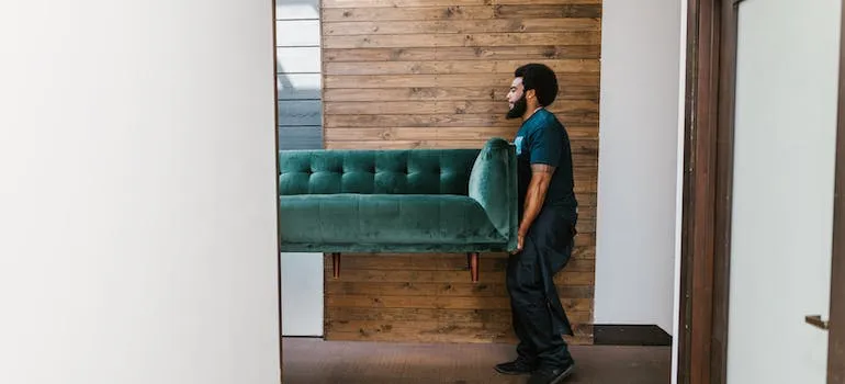 A mover relocating a sofa 