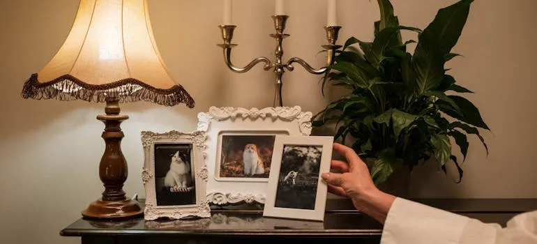A person holding a white photo frame