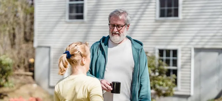 Two seniors in front of the house talking whether to retire in Maryland or Virginia