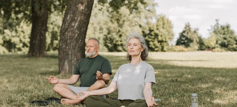 A senior couple meditating