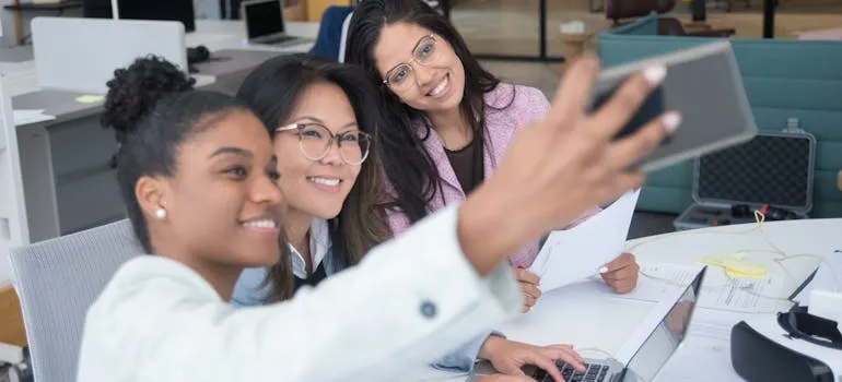Three women taking selfie