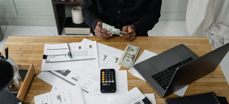A person counting dollar bills