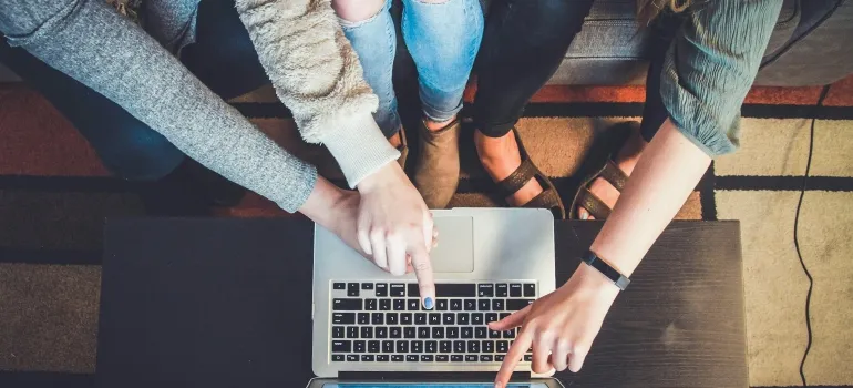 Picture of people looking at a laptop