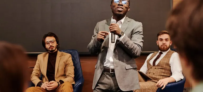 A person speaking in front of the people