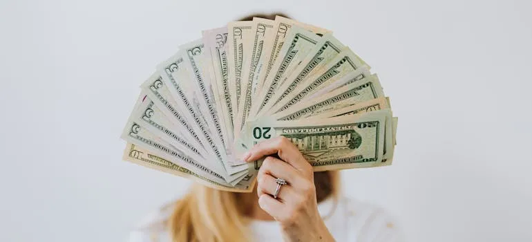 A person holding dollar bills
