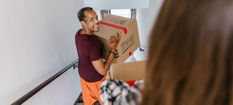 a moving professional carrying a cardboard box