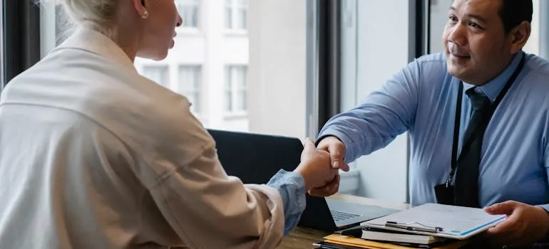 Two people shaking hands talking about reasons people relocate from Maryland to Virginia