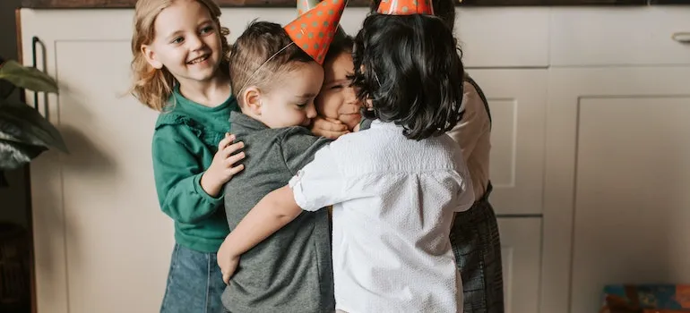 kids hugging each other on a birthday party