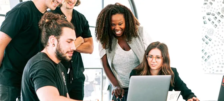 A group of people using a laptop
