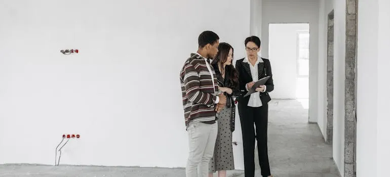 A couple with the real estate agent