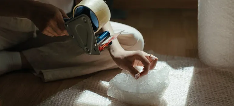 A person packing an item 