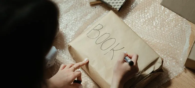 A woman packing books