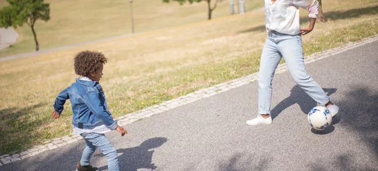 Mom and a son playing soccer