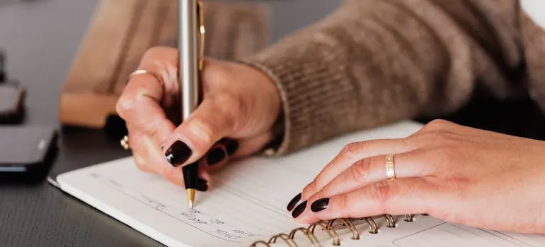 A person writing a guide to moving from Maryland to Virginia