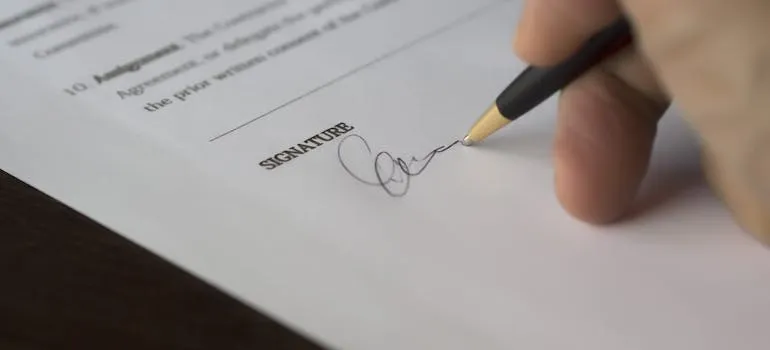 A person siging a contract