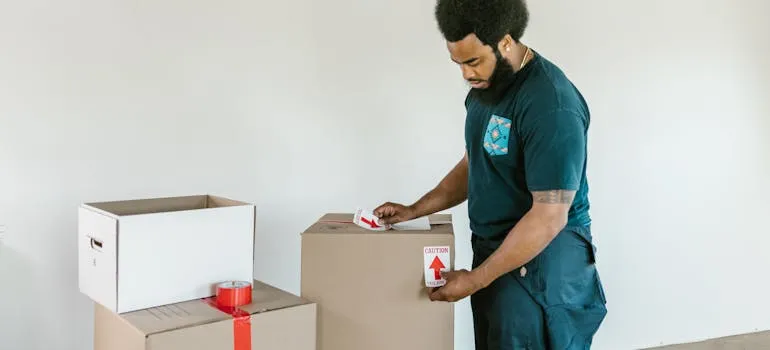 A mover packing moving boxes 