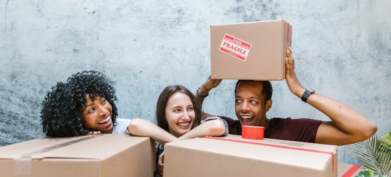 Friends surrounded by moving boxes