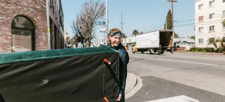 A mover carrying sofa