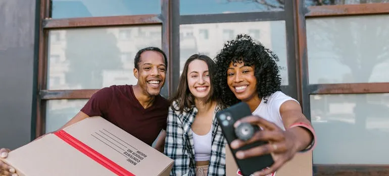 Three people who are moving from DC to California taking a selfie