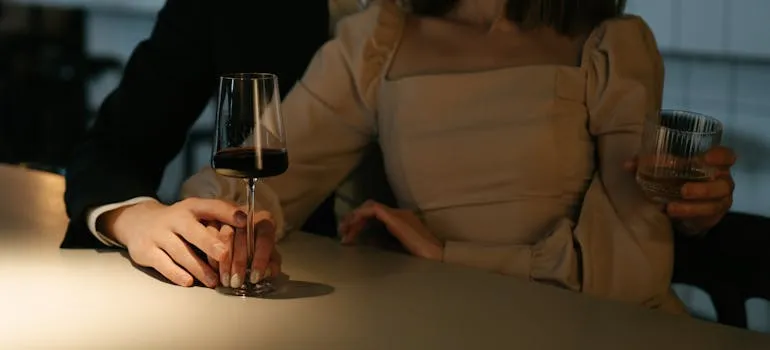 A couple holding a glass of wine in one of the most romantic cities in Maryland