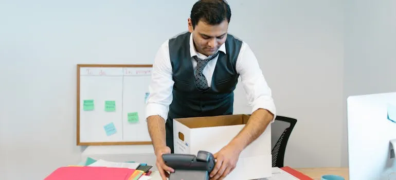 A man packing for an office relocation from Maryland