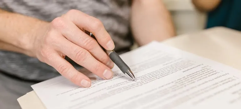 A person looking at the lease agreement