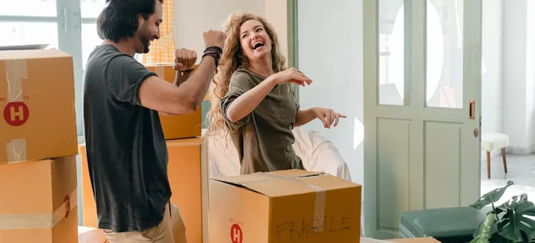 A couple dancing next to the moving boxes