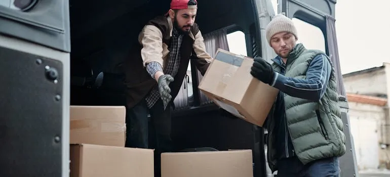 Two people loading moving van