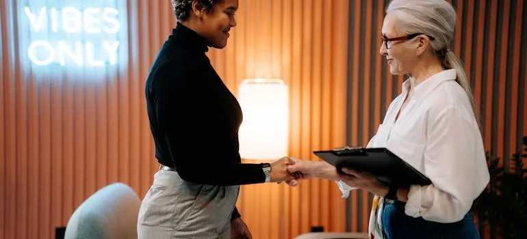 Two women shaking hands 