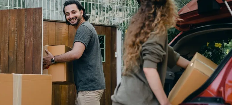 a man and woman packing to move to Northern Virginia and make some new friends