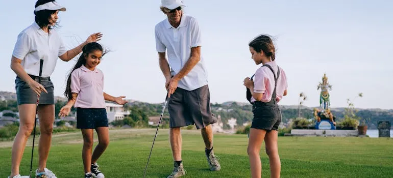 A family playing golf, one of the family-friendly activities in Northern Virginia