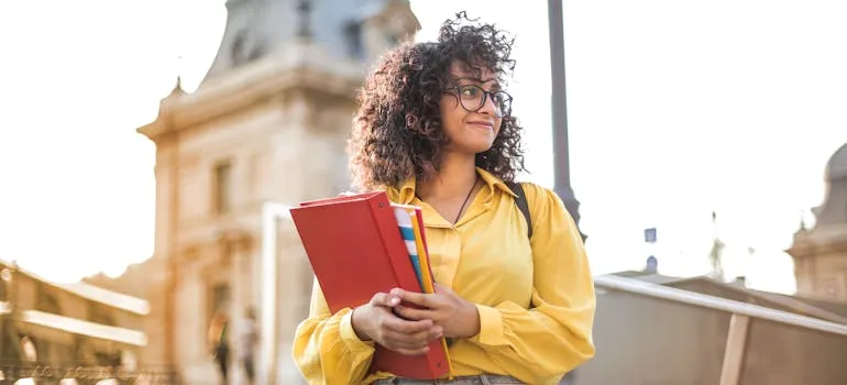 A student holding books 