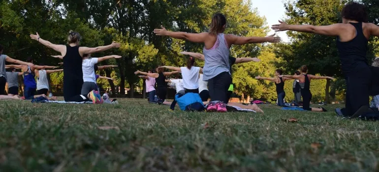 a group of people doing yoga in the nature