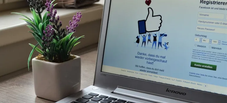 a photo of laptop and Facebook on desktop