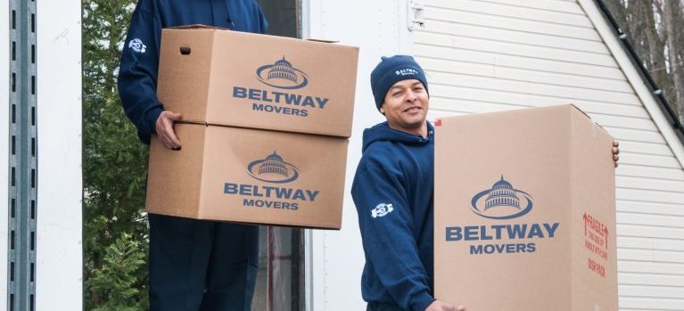 Beltway movers carrying moving boxes they've previously packed