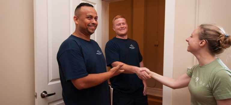 A woman shaking hands with a Beltway worker after a completed moving job